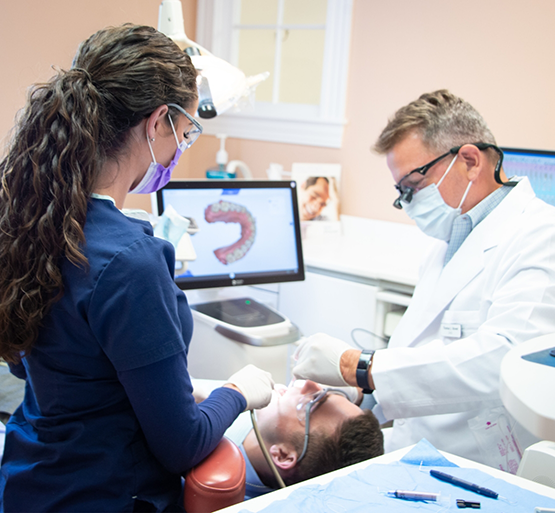 Dentist and team member treating a dental patient