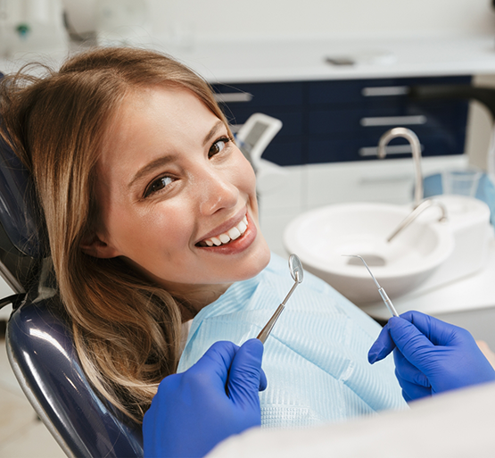 Female dental patient smiling right before dental cleaning
