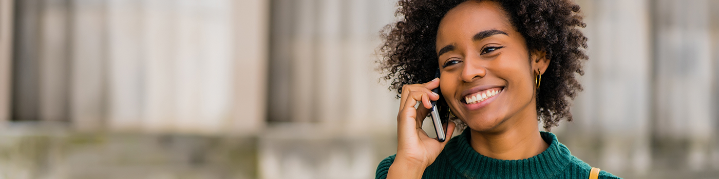 Woman in green sweater talking on cell phone