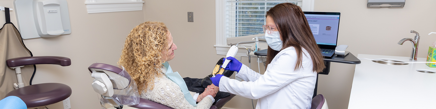 Multiple people in a row with arms over each others shoulders