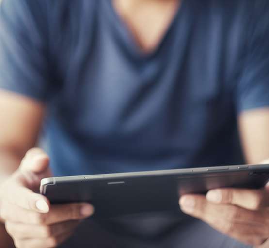 Hands holding a tablet