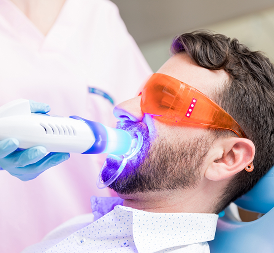 Man in dental chair having teeth whitened