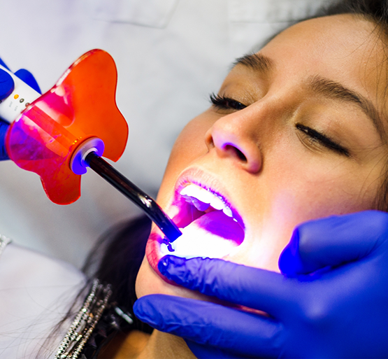Female patient undergoing dental bonding